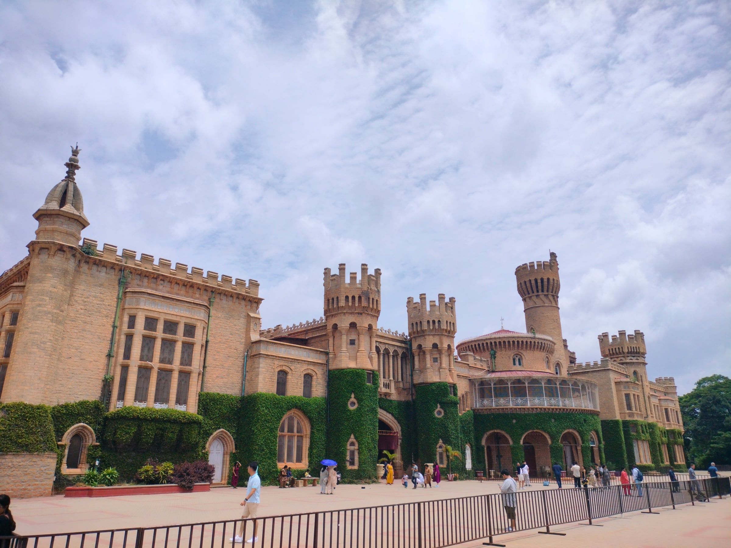 A turreted stone palace under a sky full of clouds