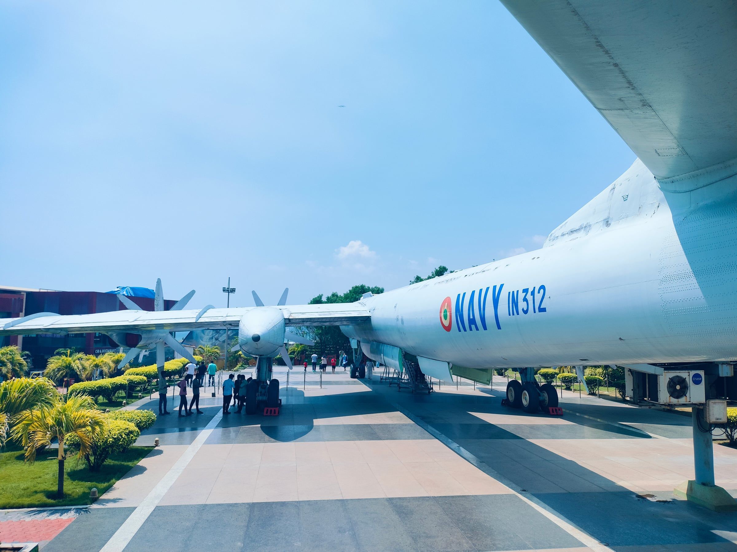 A navy aircraft on display, seen from under its wing
