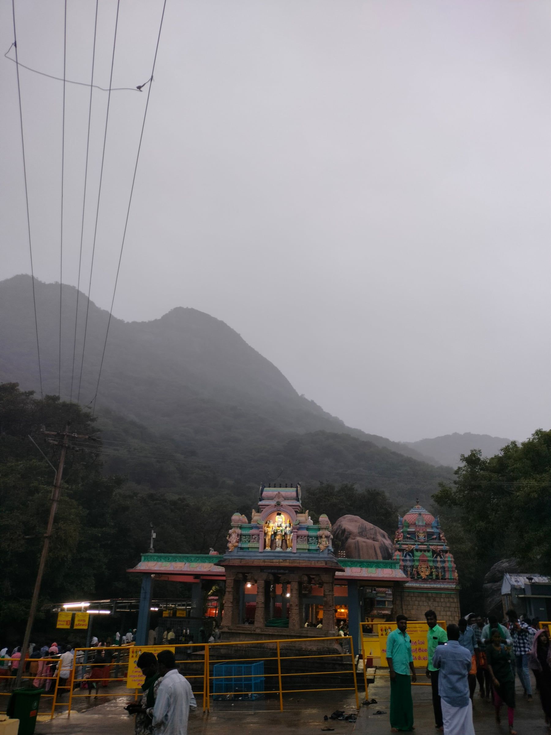 A temple at the foot of misty hills