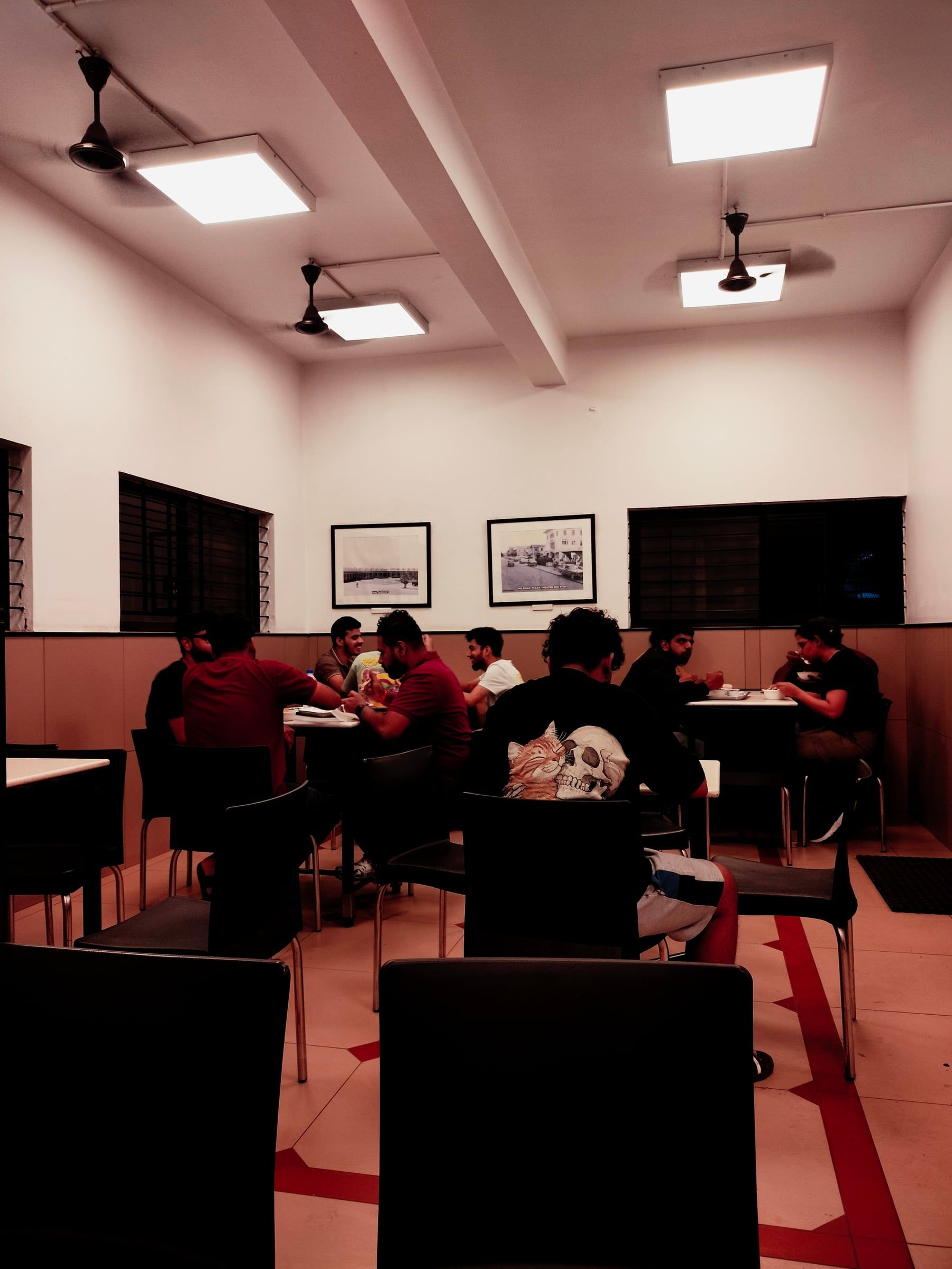 People eating in a brightly lit canteen